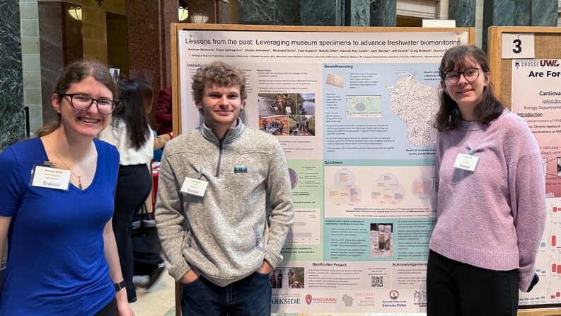 researchers presenting a poster