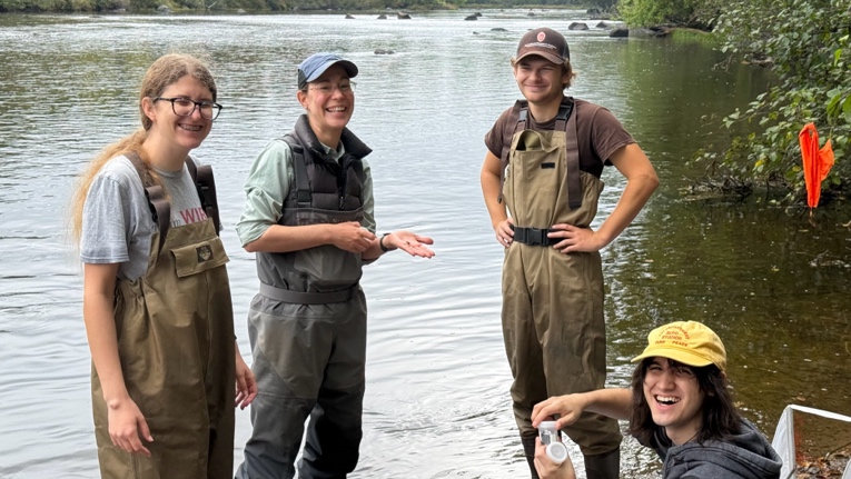group photo wading in a river